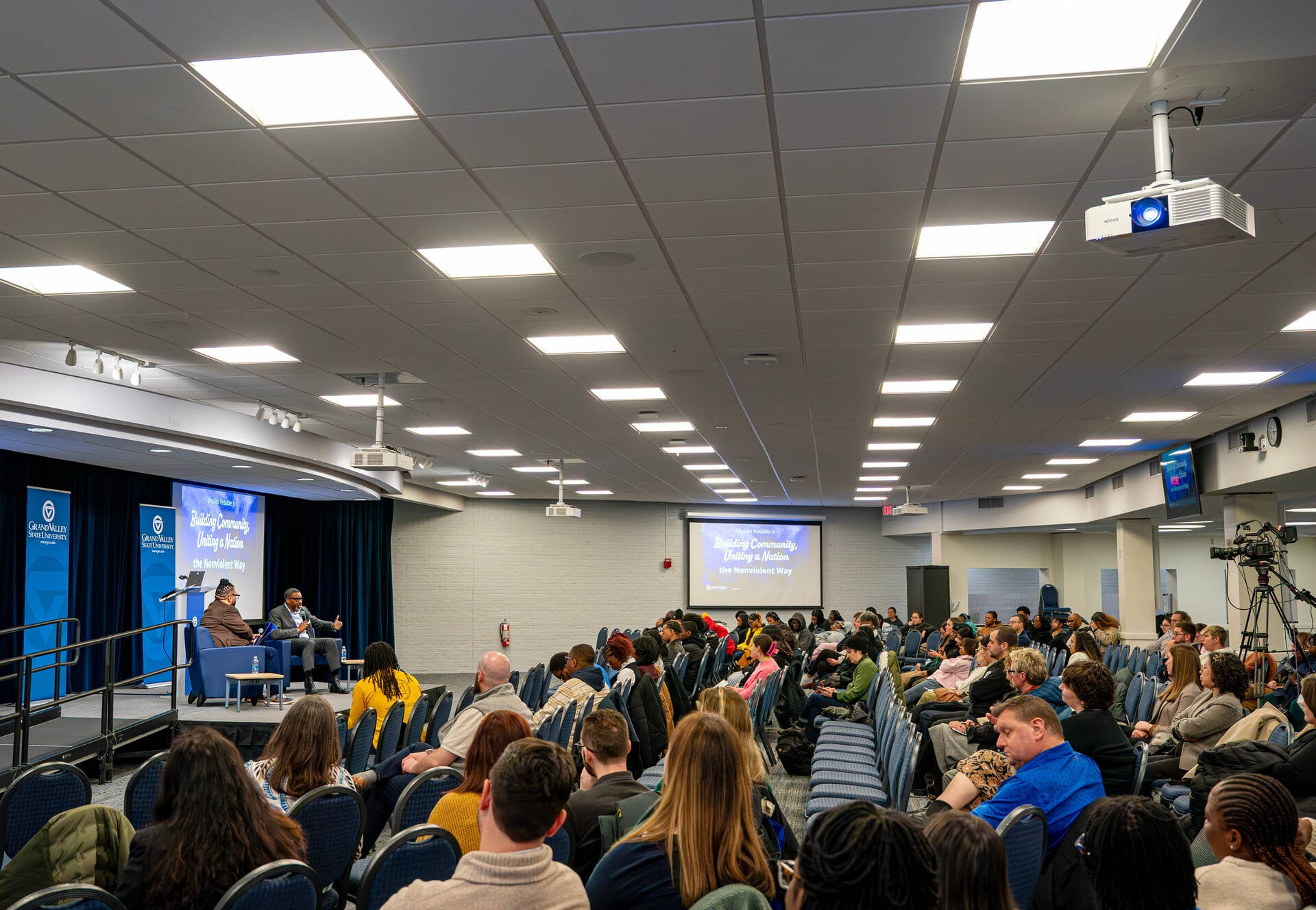 Derrick Johnson speaks at a podium in the Kirkhof Center during MLK Commemoration Week